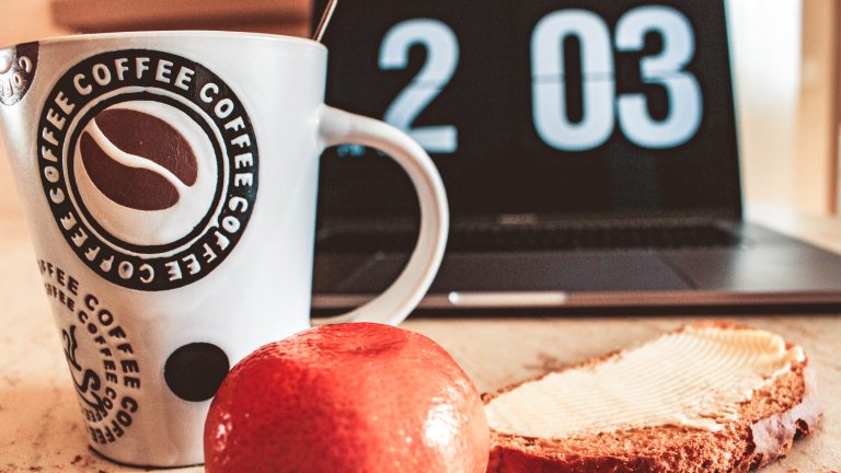 Clocks, coffee, apple and sandwich