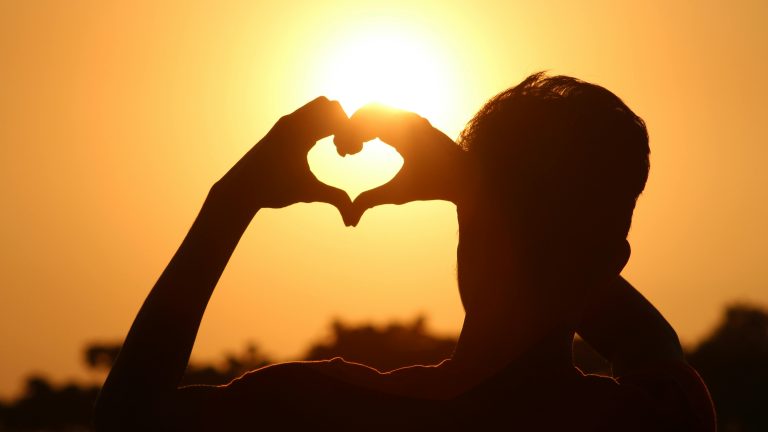 Man showing the heart symbol